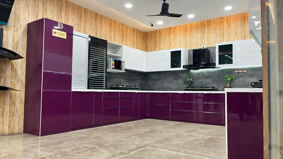 L-shaped modular kitchen display with purple gloss base units and white overhead cabinets
