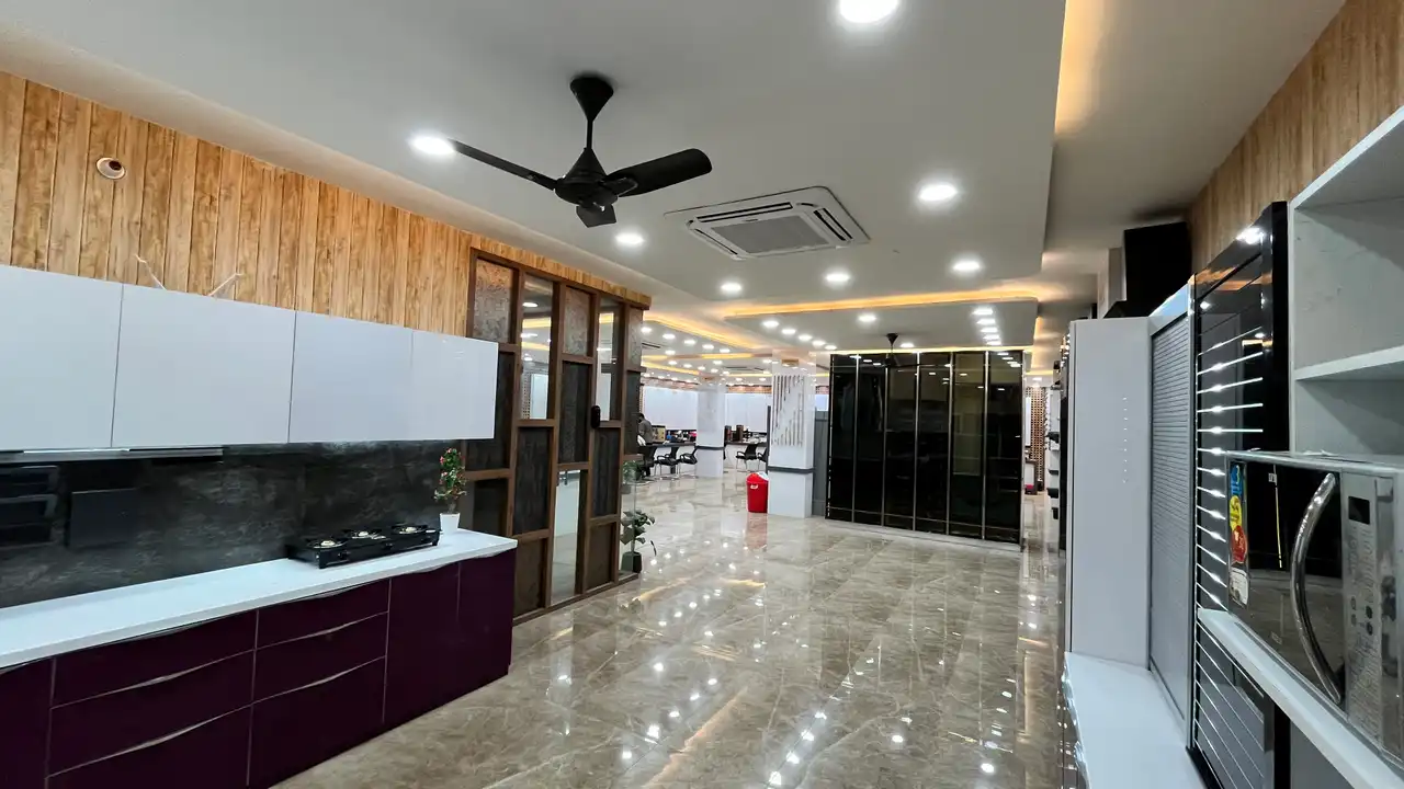 Showroom interior with modular kitchen display, wardrobe units and polished floor