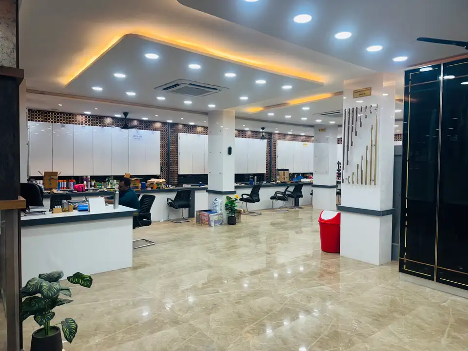 Open showroom floor with service counters, handle displays and wardrobe unit